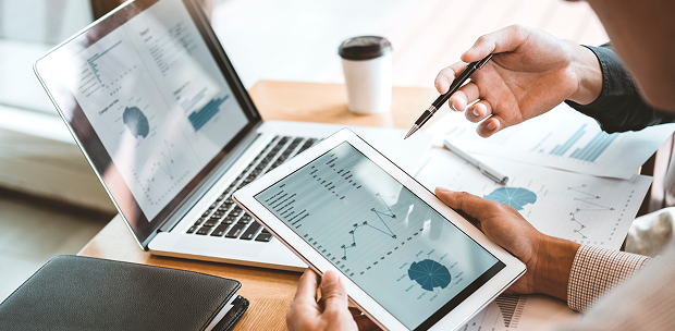 Advisor reviewing coordinated wealth management and investment performance charts on a tablet.