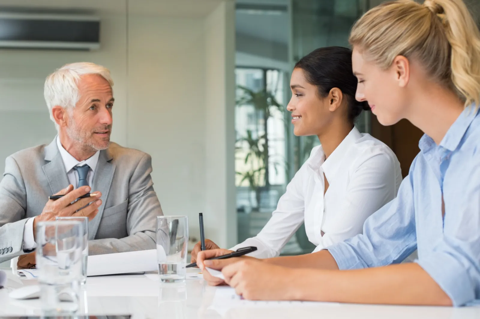 Personal CFO meeting with two clients at a conference table